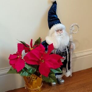 Blue Santa Figurine with Red Poinsettia and Gold Accents